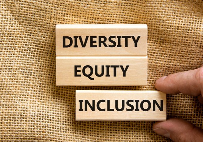 Diversity equity inclusion symbol. Concept words diversity equity inclusion on blocks on beautiful canvas table canvas background. Businessman hand. Business, diversity equity inclusion concept.